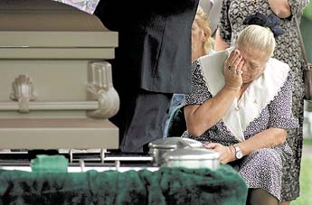 Mother of Bryan Lee Curtis crying at a grave